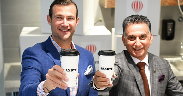 Coffee shop owners preparing artisanal coffee drinks with focus and dedication