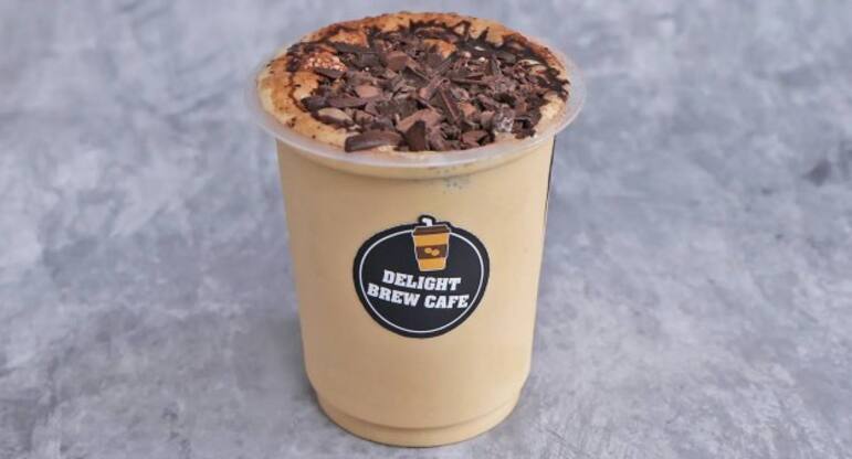 Cold brew coffee served in a clear glass with ice cubes and a citrus slice